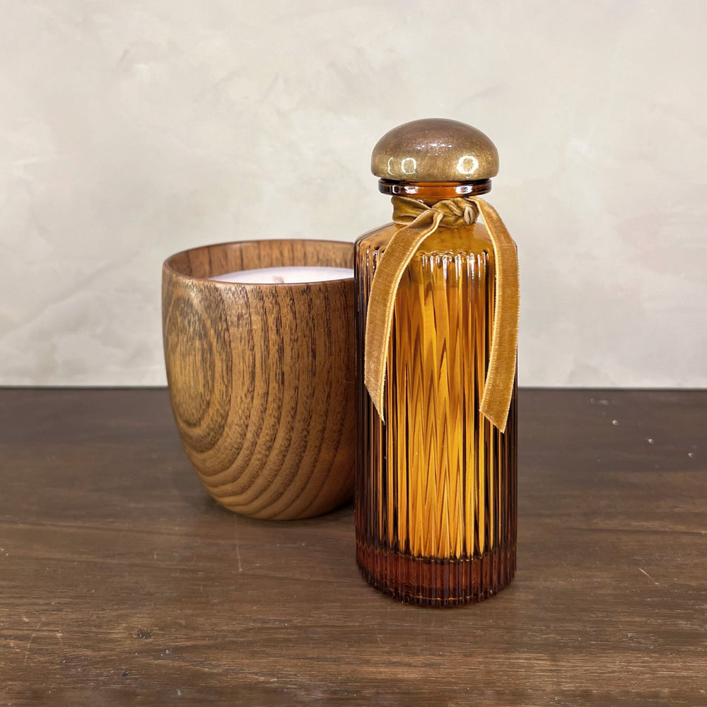 Matches in an Amber Glass Reeded Bottle with Bronze Top and Bronze Velvet Ribbon. Paired with a Wood Candle